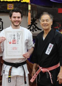 Sempai Alex Lloyd is awarded his 2nd Dan in Kobudo by Sensei Hokama, January 2017.
