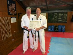 Shihan Howard Lipman presents Shihan Rick Cunningham his dojo operator license