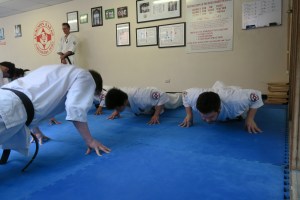 Sempai Jono demonstrates finger-tip push-ups for Shodan.